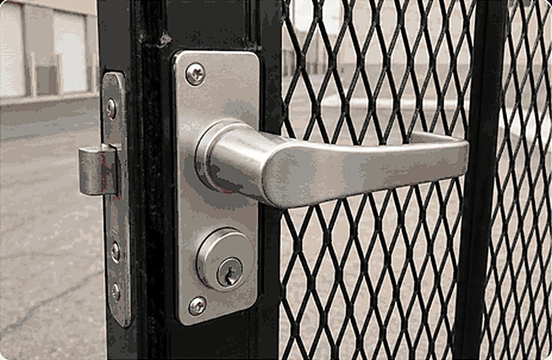Stainless lever handle and keyed cylinder on a black expanded-mesh security gate
